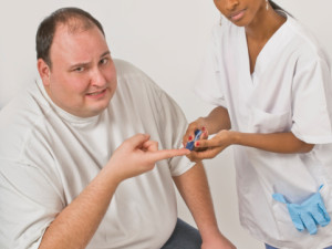 Nurse checking blood glucose