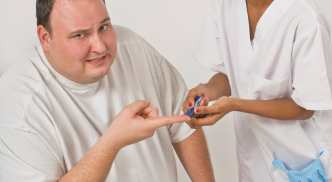 Nurse checking blood glucose