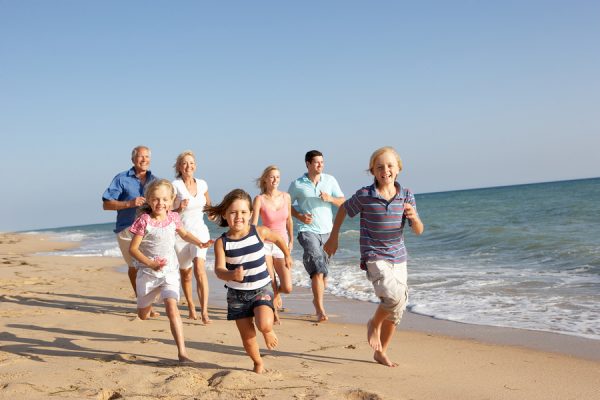 Portrait Of Three Generation Family On Beach Holiday